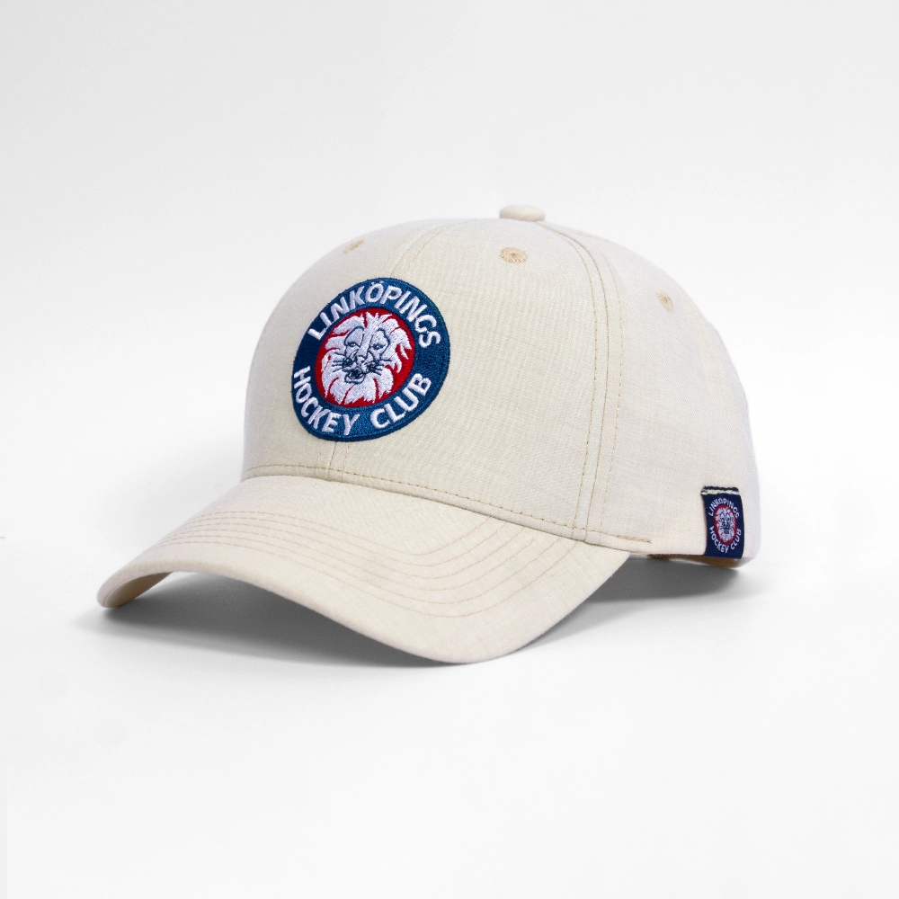 En gr&auml;ddf&auml;rgad baseballkeps med Link&ouml;pings Hockey Clubs (LHC) broderade cirkul&auml;ra logotyp framtill, med ett lejonhuvud i r&ouml;tt, vitt och bl&aring;tt.